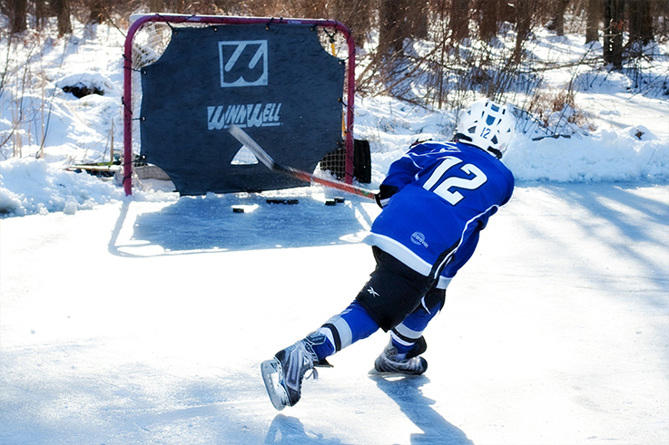 Child practicing hockey outdoors