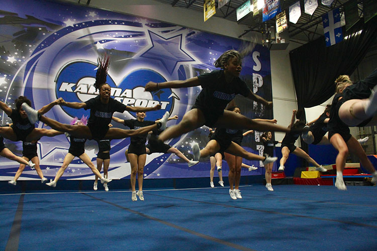 Cheerleaders practicing jumps