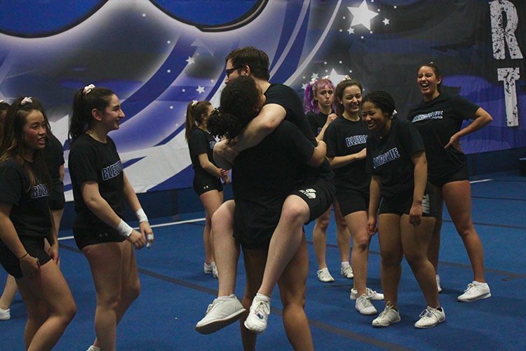 Cheerleaders hugging during practice