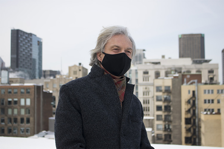 A portrait of Clausen with the Montreal skyline