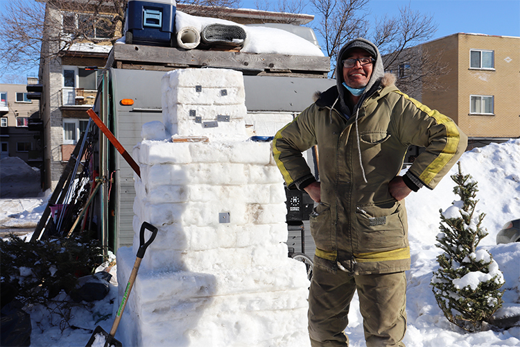 Louis Rouillard who is homeless posing with a snowman in Montreal