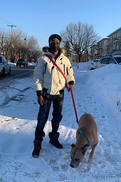 Pradel Clement, who has been subject to racial profiling, and his dog in Laval.