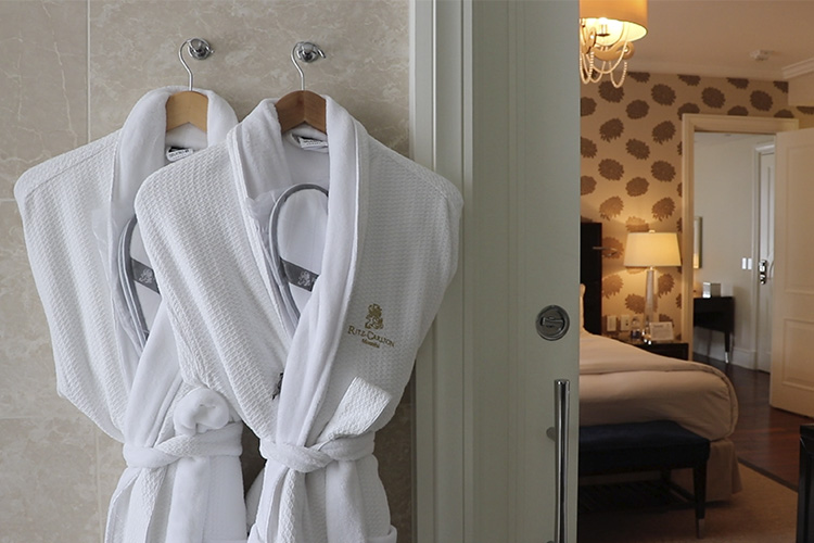Hotel bathrobes on a hanger.