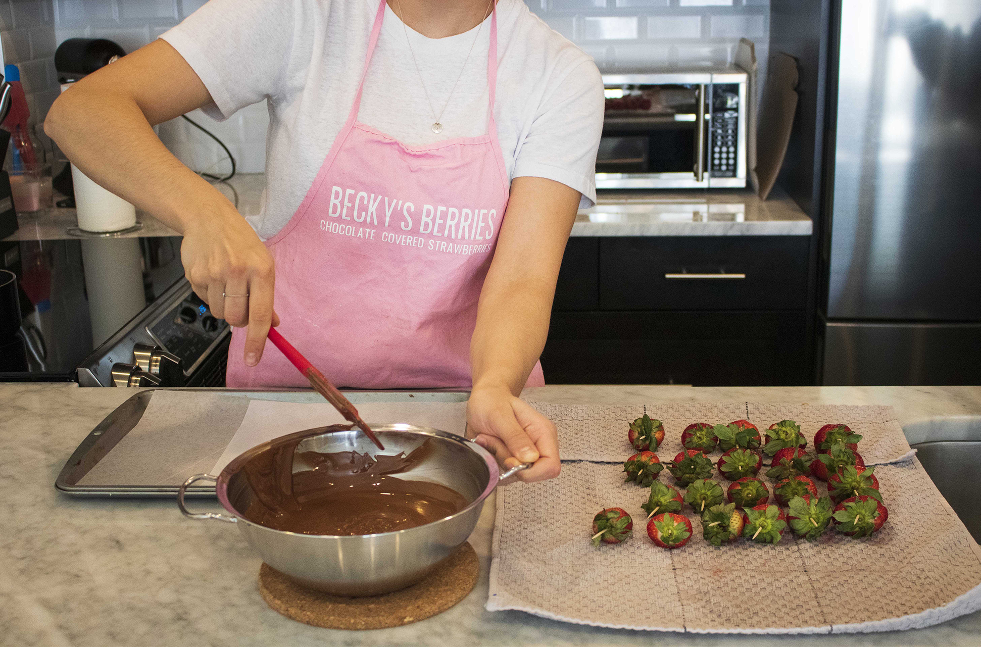 Rebecca Caporicci making her chocolate-covered strawberries.