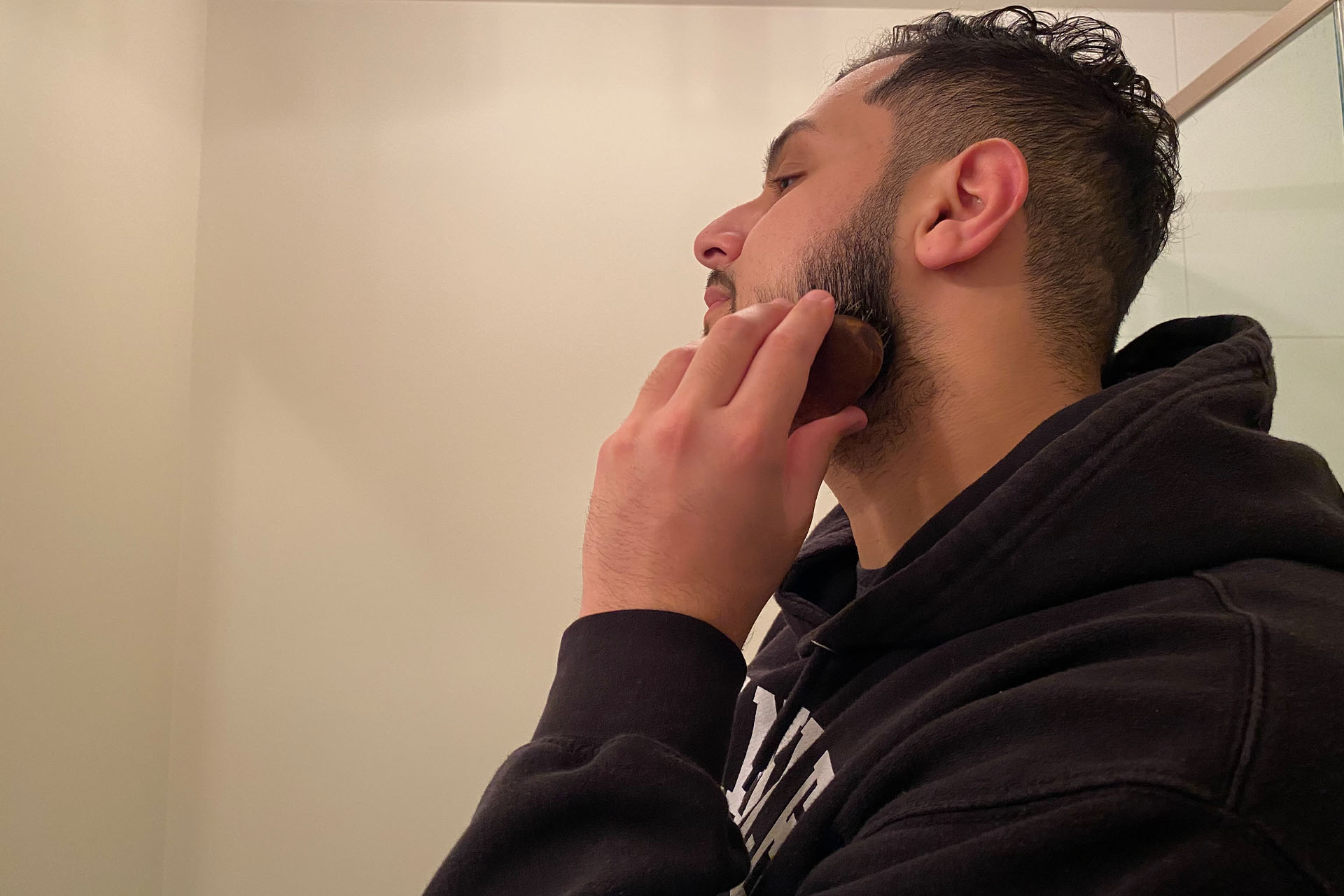 A man brushes his beard