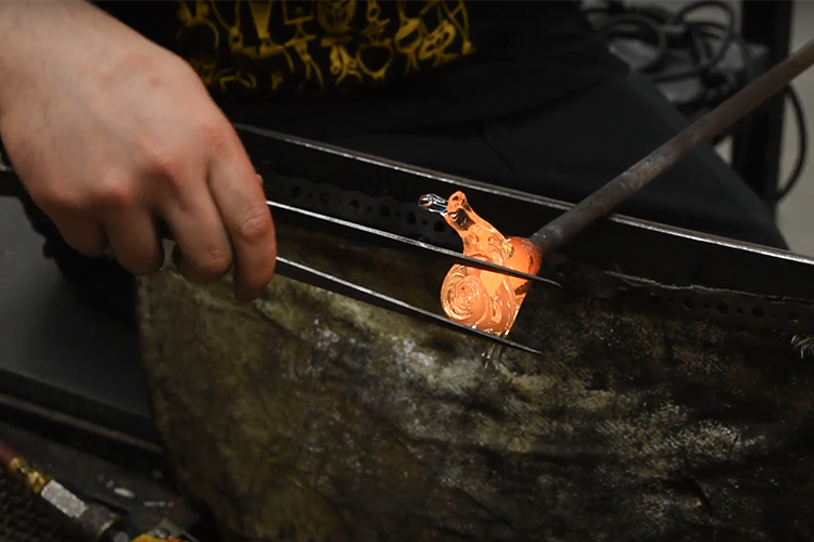 A close of of an artisanal glass-blown snail being created