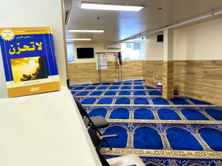 The inside of a mosque in downtown Montreal with its empty blue carpet were worshippers normally pray side by side looking towards Mecca.