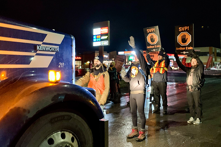 Activists stop a pig transportation truck before the slaughterhouse