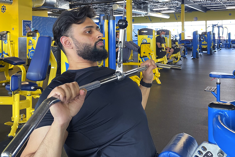 Personal trainer Sahil Patel doing some lat pulldowns on the machines at Buzzfit DDO.