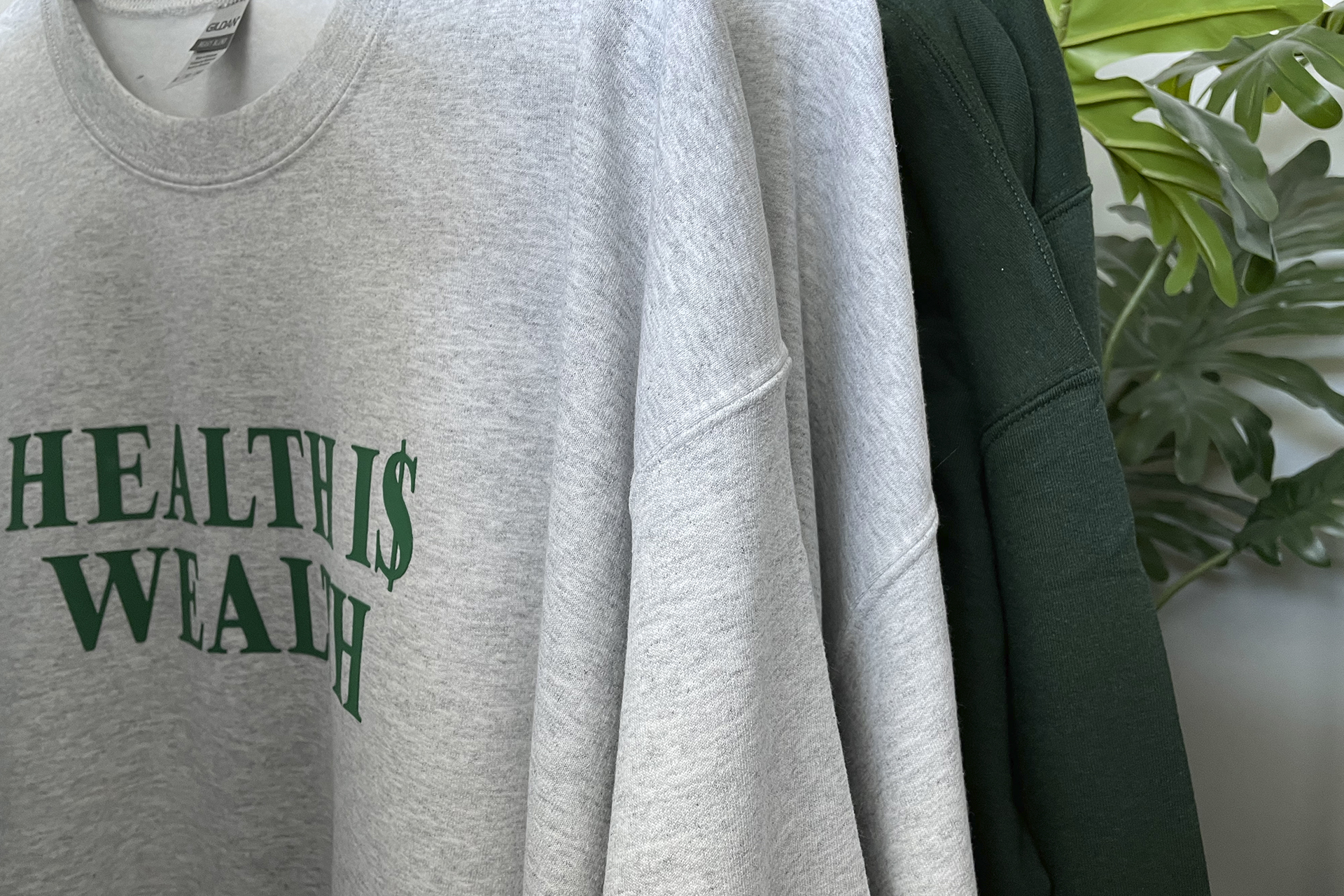 Be Well With Kayla merchandise sweatshirts that say Health is Wealth on the front.