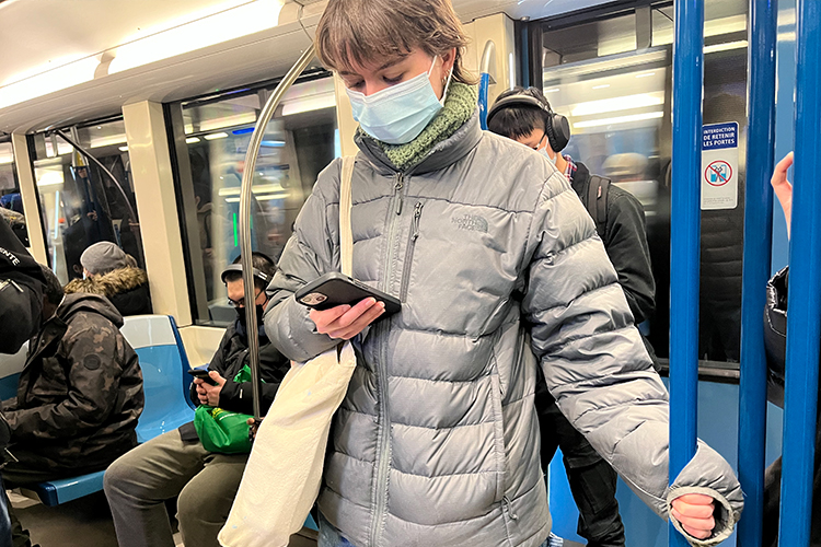 Woman browsing phone on metro