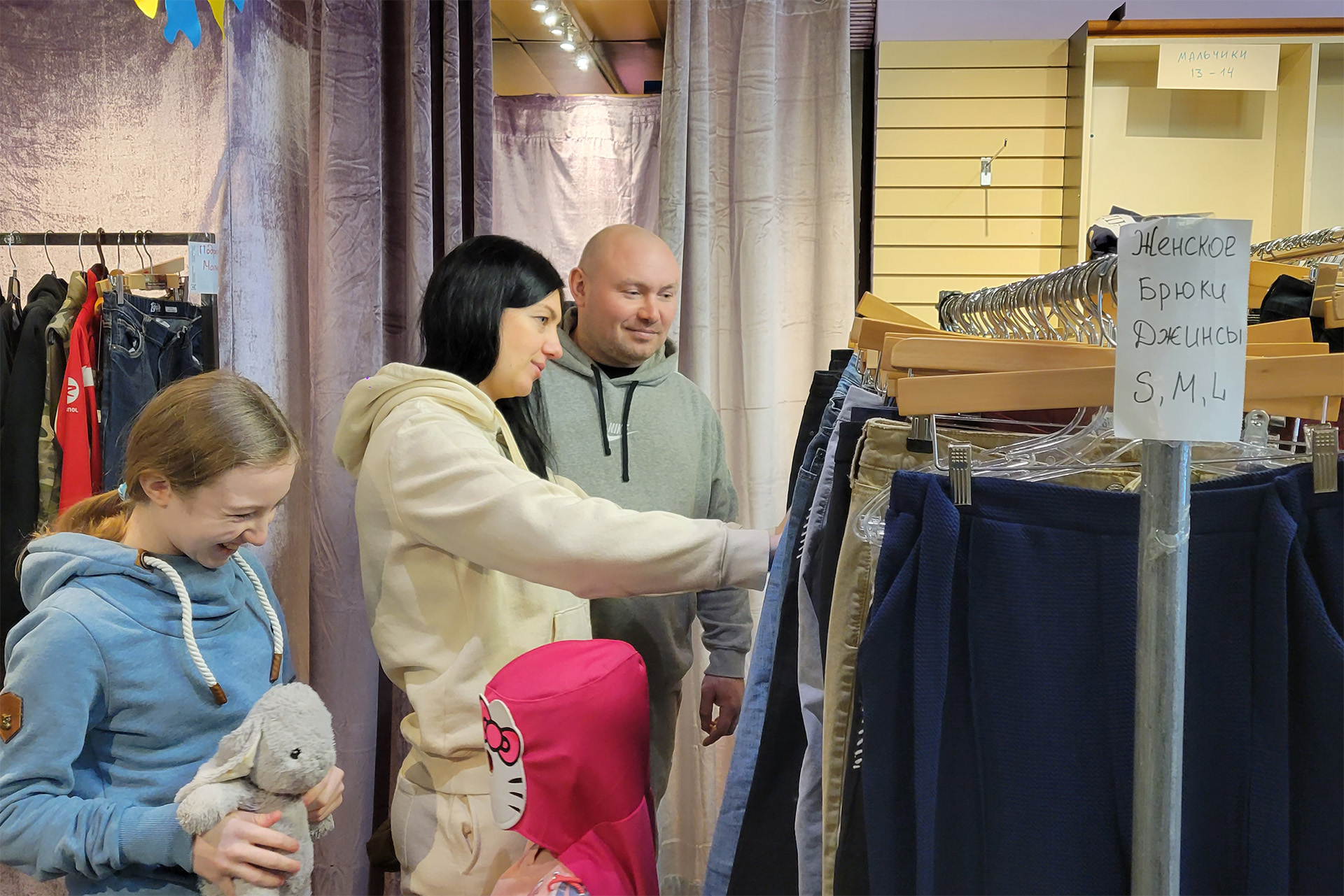 A family of four looks at clothes at the donations centre.