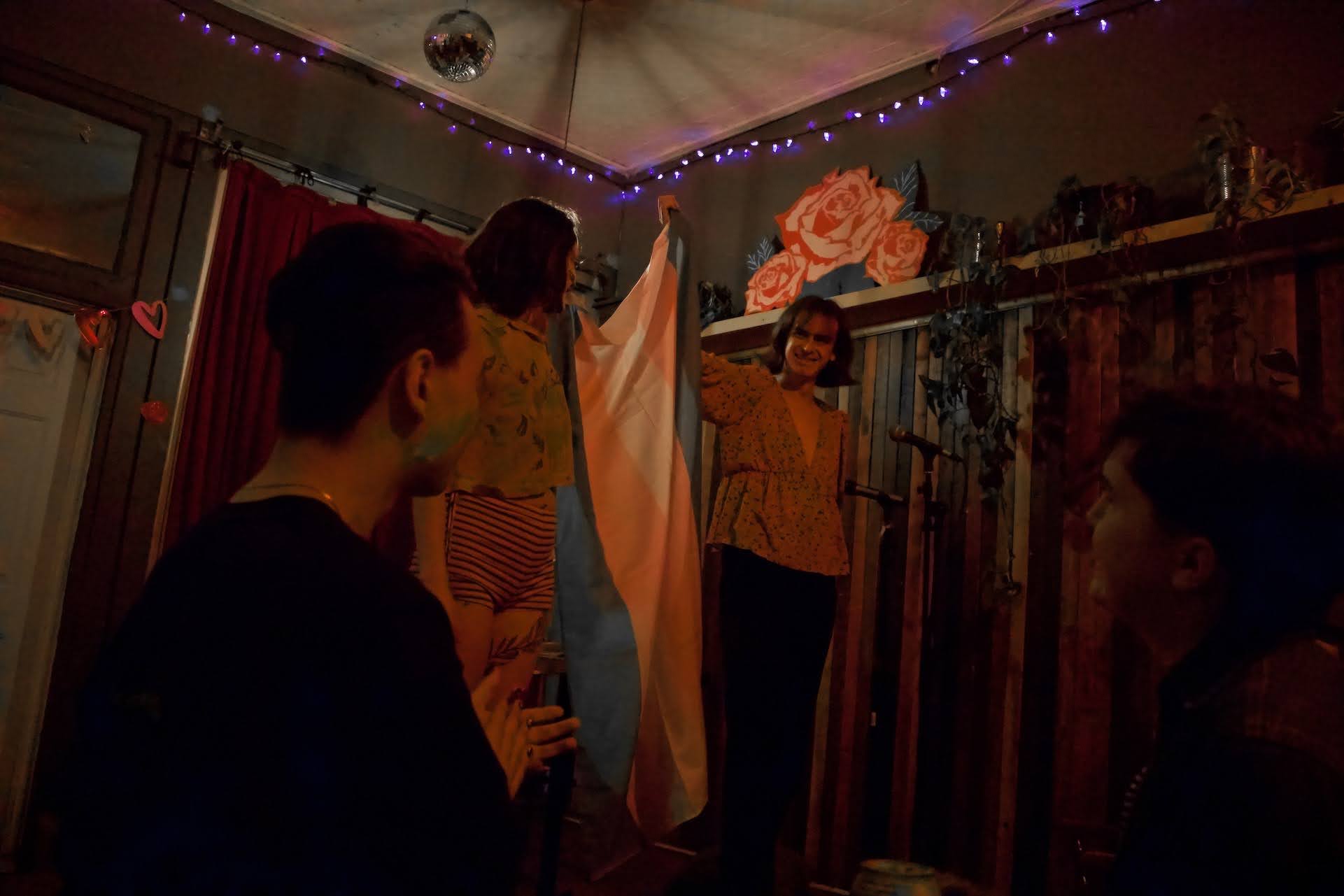 Two performers holding up a trans flag