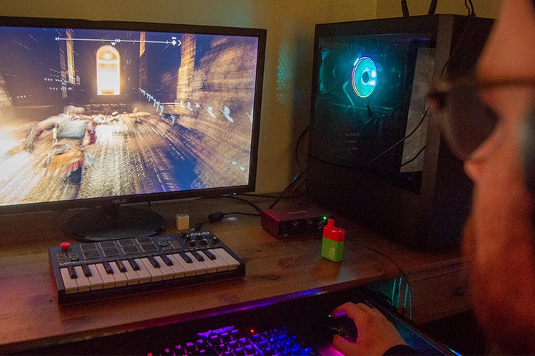 Cody Dodds plays God of War on his PC. Photo by Thomas Quinn.