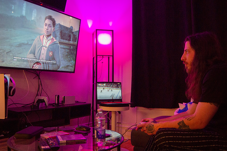Alex Noël plays the newly released video game, Hogwarts Legacy as he listens to the Montreal Canadiens hockey game. Photo by Thomas Quinn.