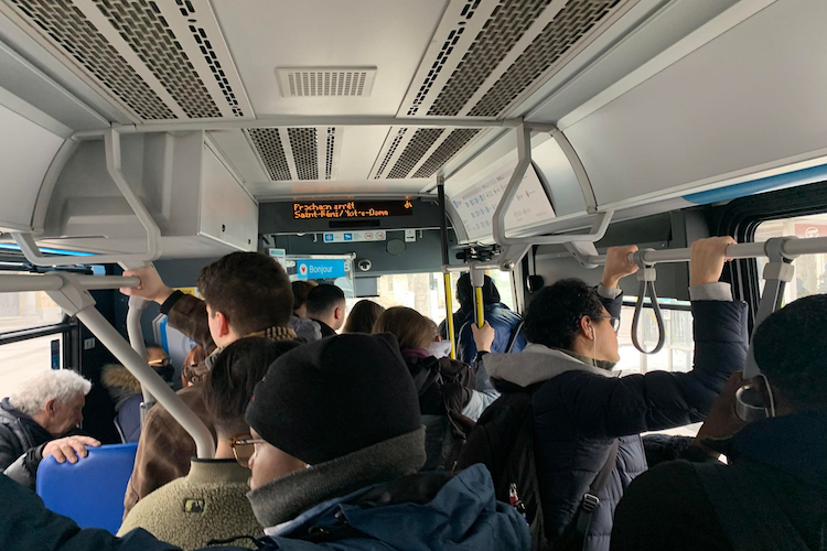 interior of a bus full of people