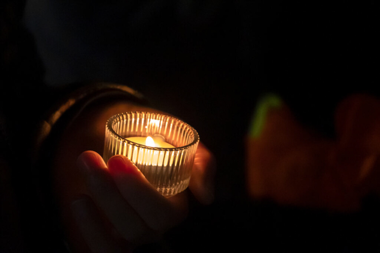 A protester holds a candle in commemoration to the missing and murdered.