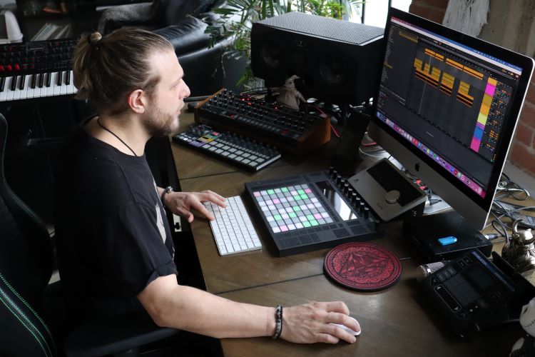 Atroxx working on his music at his home studio. Photo by Naftalia Allison
