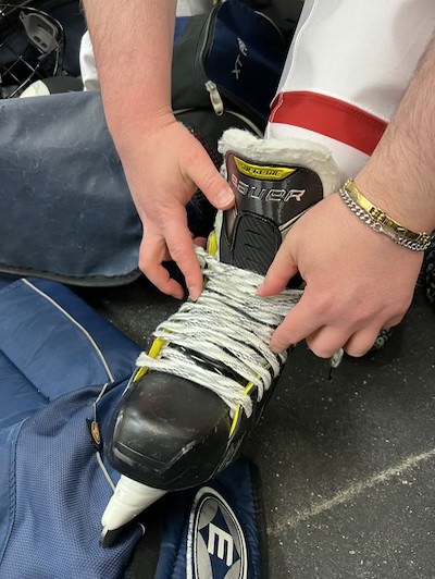 Close up of hockey player tying his skates