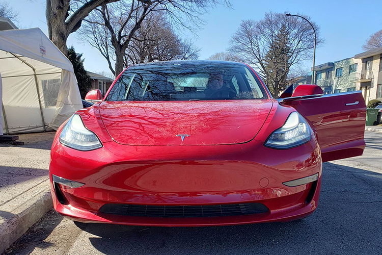 Front-facing red Tesla Model 3
