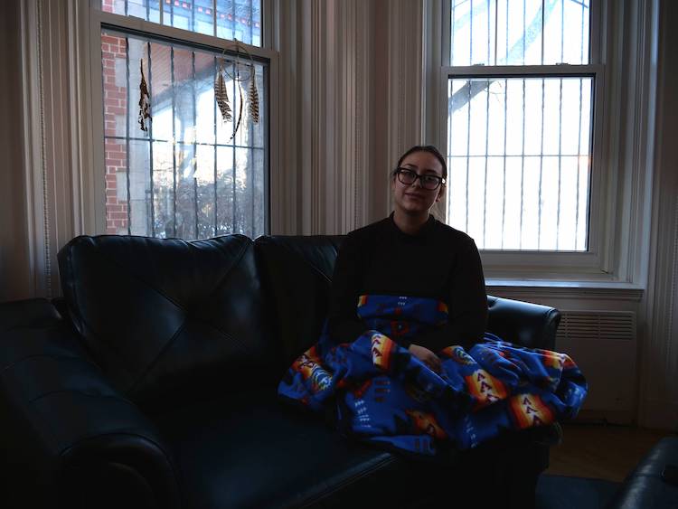 Amy Edward sitting on a couch at the First Peoples Justice Centre of Montreal.