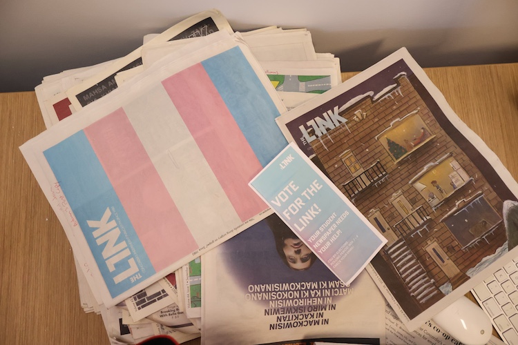 A stack of scattered Link newspapers